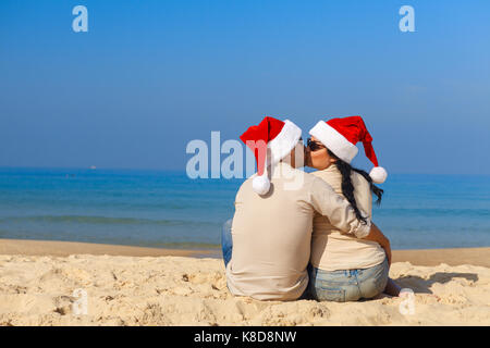 Christmas couple having fun on a beach Stock Photo