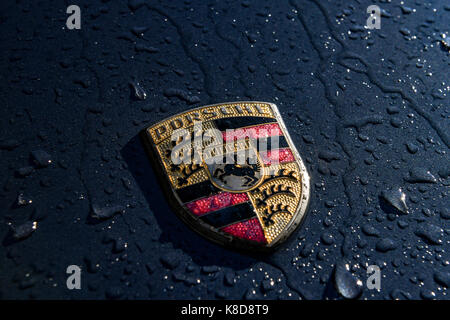 Close up of Porsche badge with rain drops on Stock Photo