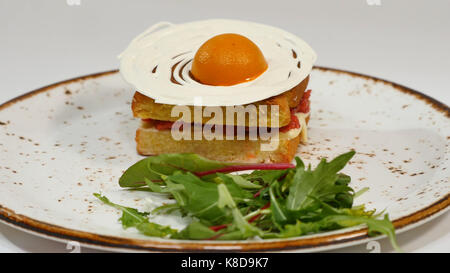 Sponge cake with strawberries, jam and whipped cream with a cut out piece Stock Photo