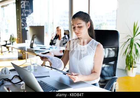 Two business women in the office working. Stock Photo