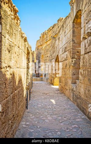 EL DJEM, TUNISIA - SEPTEMBER 1, 2015: The narrow corridor of  El Jem amphitheater with preserved stone walls, on September 1 in El Djem. Stock Photo