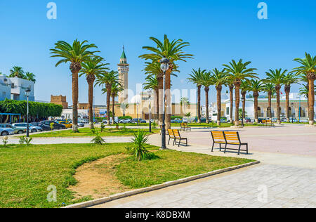 The scenic park with palms in front of Ribat fortress, the mosque of Habib Bourguiba is seen behind the trees, Monastir, Tunisia. Stock Photo