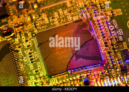 Cracked CPU (broken processor chip, broken CPU) on circuit board - USA Stock Photo