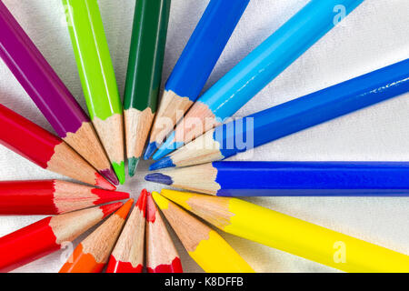 Color pencils in round formation on white background. Shot at close-up with composition centre at lower left Stock Photo