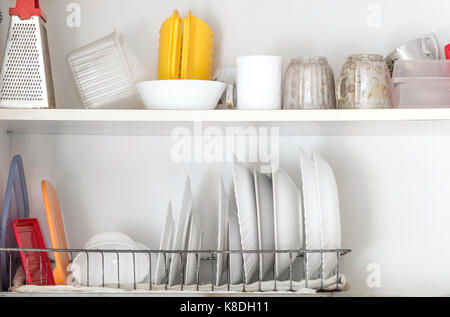 Clean dishes are in the kitchen cupboard. Stock Photo
