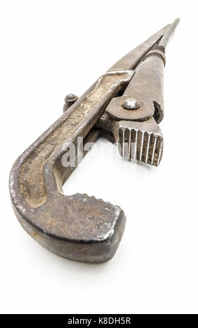 Big old rusty adjustable wrench close-up on a white background. Stock Photo