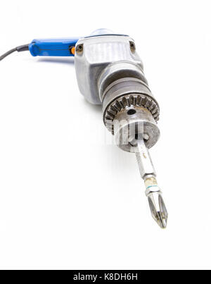 Old electric screwdriver close-up on a white background. Stock Photo
