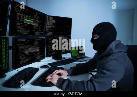 Hacker Using Computers With Multiple Monitors Stock Photo - Alamy