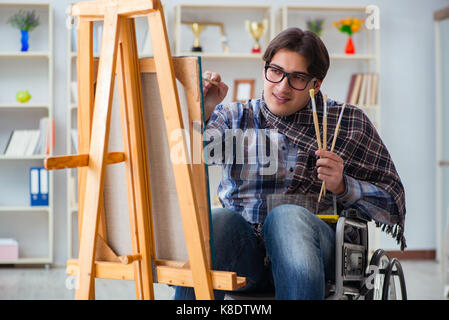 Disabled artist painting picture in studio Stock Photo