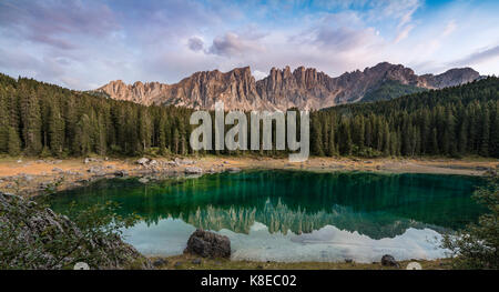 Sunset, dramatic clouds, Latemar group reflected in the Karersee, Diamantidturm, mountain peaks, Eastern Latemarspitze Stock Photo