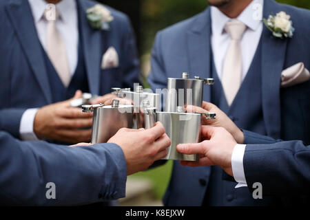 a toast with hip flasks at a wedding. Stock Photo