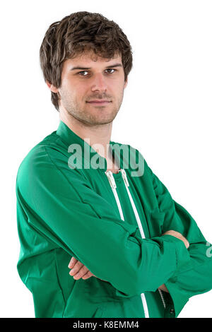 worker wearing green working coat crossed arms on white Stock Photo