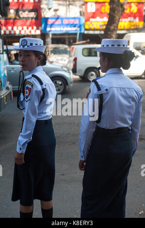 26.01.2017, Yangon, Yangon Region, Republic of the Union of Myanmar, Asia - Two female traffic police officers stand at the side of a road in Yangon. Stock Photo