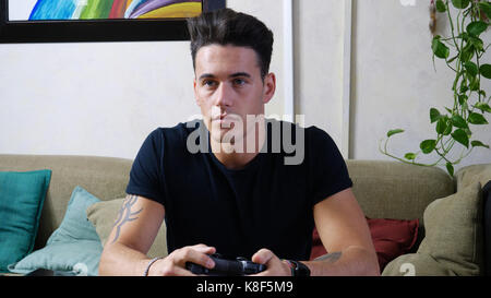 Young man using joystick or joypad for videogames Stock Photo
