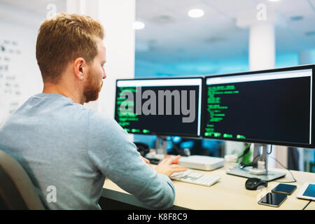 Portrait of young programmer working in office Stock Photo