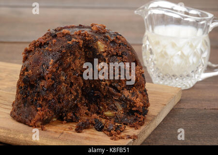 closeup christmas pudding on wood cutting board Stock Photo