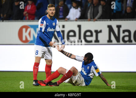 Kiel, Germany. 19th Sep, 2017. Kiel's Alexander Bieler (L) helps his team mate to get up after the German Second Bundesliga soccer match between Holstein Kiel and FC St. Pauli in the Holstein-Stadion in Kiel, Germany, 19 September 2017. (EMBARGO CONDITIONS - ATTENTION: Due to the accreditation guidelines, the DFL only permits the publication and utilisation of up to 15 pictures per match on the internet and in online media during the match.) Credit: Axel Heimken/dpa/Alamy Live News