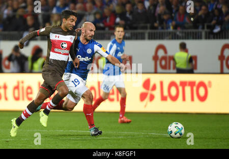 Kiel, Germany. 19th Sep, 2017. Kiel's Patrick Herrmann in action against Pauli's Sami Allagui (L) during the German Second Bundesliga soccer match between Holstein Kiel and FC St. Pauli in the Holstein-Stadion in Kiel, Germany, 19 September 2017. (EMBARGO CONDITIONS - ATTENTION: Due to the accreditation guidelines, the DFL only permits the publication and utilisation of up to 15 pictures per match on the internet and in online media during the match.) Credit: Axel Heimken/dpa/Alamy Live News