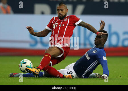 Gelsenkirchen, Germany. 19th Sep, 2017. Arturo Vidal (L) of Bayern Munich vies for the ball with Breel Embolo of Schalke 04 during their German Bundesliga match in Gelsenkirchen, Germany, on Sept. 19, 2017. Bayern Munich won 3-0. Credit: Joachim Bywaletz/Xinhua/Alamy Live News Stock Photo