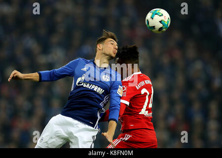 Gelsenkirchen, Germany. 19th Sep, 2017. Leon Goretzka (L) of Schalke 04 vies for the ball with Corentin Tolissoof of Bayern Munich during their German Bundesliga match in Gelsenkirchen, Germany, on Sept. 19, 2017. Bayern Munich won 3-0. Credit: Joachim Bywaletz/Xinhua/Alamy Live News Stock Photo