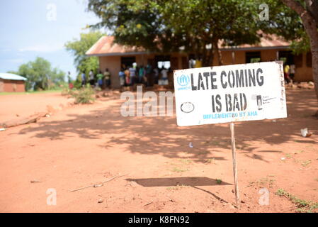 Imvepi, Uganda. 27th June, 2017. A sign reading 'Late Coming is bad' can be seen at the refugee settlement in Imvepi, Uganda, 27 June 2017. More than two million people have fled the civil war in South Sudan, one million of them in Uganda. Credit: Gioia Forster/dpa/Alamy Live News Stock Photo