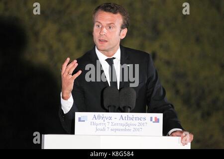 French President Emmanuel Macron delivers a speech at Pnyx hill as the ancient site of Acropolis is seen in the background in Athens. Standing at a Gr Stock Photo