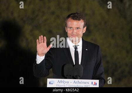 French President Emmanuel Macron delivers a speech at Pnyx hill as the ancient site of Acropolis is seen in the background in Athens. Standing at a Gr Stock Photo