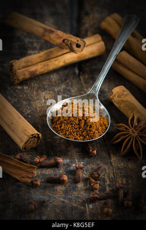 Spices - cinnamon and cloves on wooden table - closeup with selective focus Stock Photo