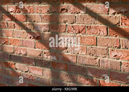 York Old Clamp red brick wall with scaffolding tube shadows. Stock Photo