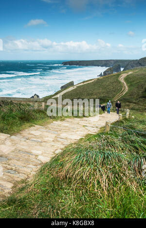 Bedruthan Steps - walkers climbing up the steep footpath at Bedruthan Steps on the North Cornwall coast. Stock Photo