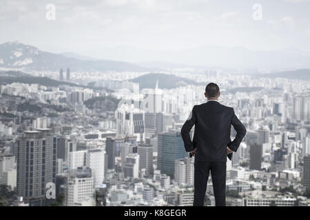 man in suit looking to cityscape,Business concept Stock Photo