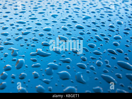 Water drops on blue, detail of a wet blue surface water Stock Photo