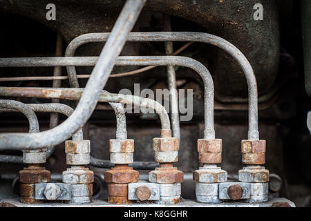 close up old rusty iron pipe and scrull in engine power matchine industry in dark Stock Photo