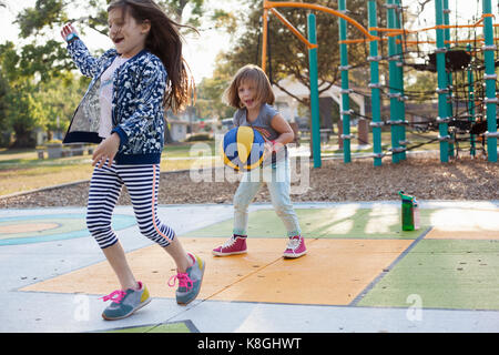 Children playing basketball in playground Stock Photo