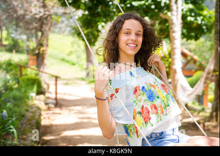 Girl on swing, Rio de Janeiro, Brazil Stock Photo