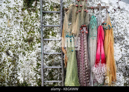 Fishing nets hanging from wall at Isola Pescatori, Lake Maggiore Piedmont, Italy Stock Photo