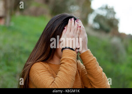 Outdoor portrait of teenager girl covering her face Stock Photo