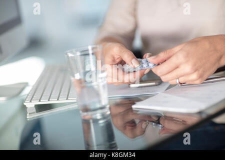 Cropped view of woman taking pills Stock Photo