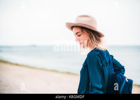 Mid adult woman walking along beach Stock Photo