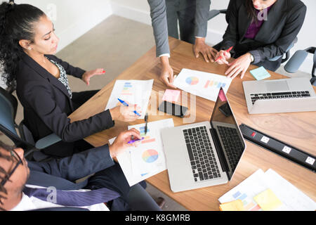 Businessman and businesswomen, in office, using laptops Stock Photo