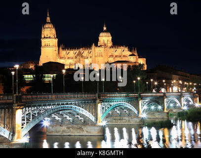 Salamanca skyline at night and Enrique Esteban Bridge over Tormes River in Spain Stock Photo