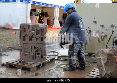 HYVINKAA, FINLAND - SEPTEMBER 8, 2017: Man shows how to make precise openings in concrete with ICS chain saw. Stock Photo