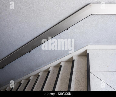 White marble staircase with the metal handrail for use in the office building. Stock Photo