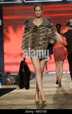 Montreal,Canada 23/08/2017 A model wearing a fur accented poncho walks on the runway at the fashion show held during the Fashion and Design Festival. Stock Photo