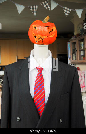 A bonfire effigy's rotting pumpkin 'head 'grows a mould fringe and starts to look uncannily like Donald Trump Stock Photo