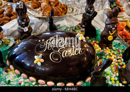 Large Chocolate decorated Easter Egg and chocolate Bunny Rabbits on display at a Easter Brunch.. Stock Photo