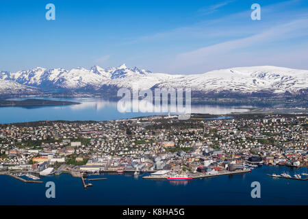 High view above old city on Tromsoya island with snow-capped mountains seen from Mount Storsteinen in summer. Tromso, Troms, Norway, Scandinavia Stock Photo