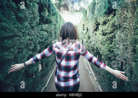 Young woman walking in the park labyrinth in Barcelona Stock Photo