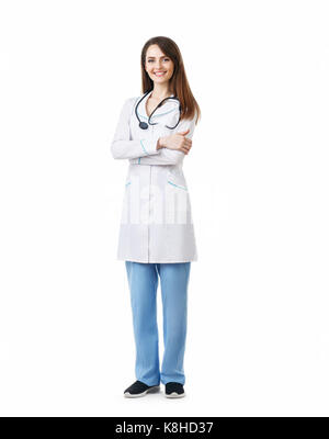 Full length portrait of beautiful smiling doctor with arms crossed isolated on white background Stock Photo