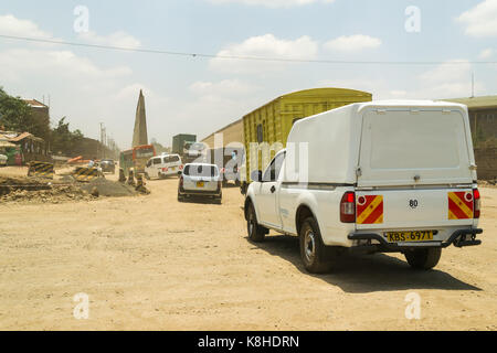 Vehicles drive down Enterprise Road whilst under construction, Nairobi, Kenya Stock Photo